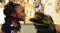 Photo of 4-year old and Twiggle the Turtle hand puppet