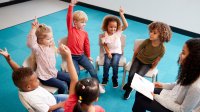 Students and teacher have circle time in pre-school classroom