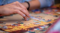 Woman working on a jigsaw puzzle
