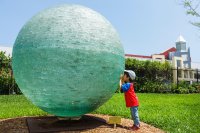 Child exploring in a sculpture garden