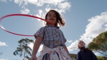 Girls play with hula hoops at Wooranna Park.