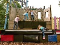Four children climbing on a play structure