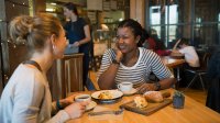 photo of two woman at a cafe table