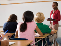 photo of teacher in front of an engaged classroom