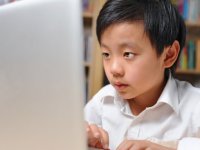 Young boy in front of computer