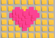 Heart made out of pink post-its surrounded by yellow post-its
