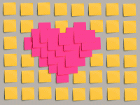 Heart made out of pink post-its surrounded by yellow post-its