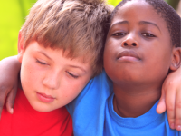 two children happily posing for the camera