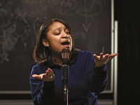 Girl expressively speaking in front of microphone