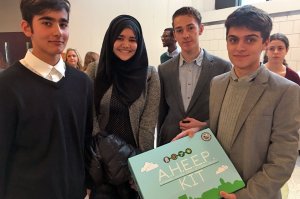 Team A.H.E.E.P., three boys and a girl standing together, one holding an A.H.E.E.P. Kit