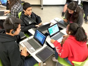 Students move their desks to work together.