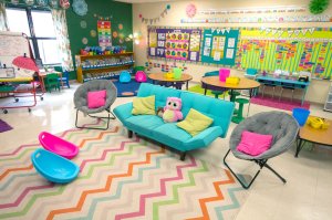 A classroom filled with colorful couches and lightweight chairs. 