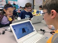 Students sitting together working on their laptops