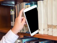 Hand pulling an iPad off the library shelf like a book