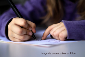 Child writing in notebook