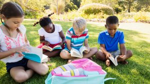 Kids reading in the park