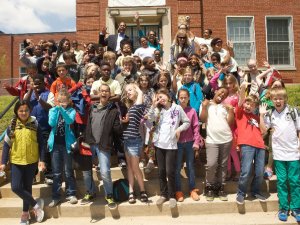 Students posing in front of school