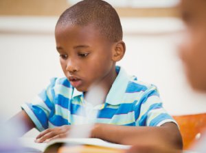 Student focusing on a book