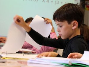 Young boy looking at his work