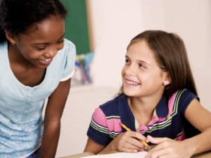 Two students collaborating, smiling