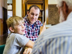 Teacher listening to a parent and child