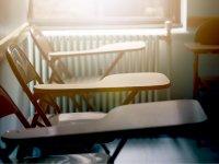 Close up of three metal folding chairs with table