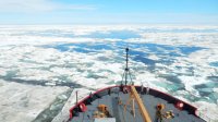 Standing on a boat overlooking a sea of ice