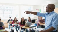 photo of a teacher in front of students in a classroom