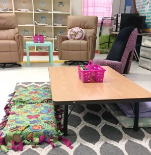 A low classroom table with floor pillow seating