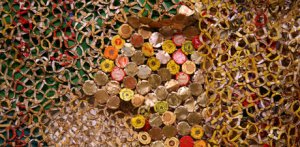 Close up of colorful metal pieces the side of bottle caps wired together