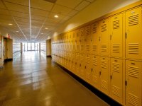 School corridor with yellow lockers lining both sides