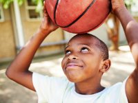 photo of smiling young man holding a basketball