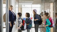 Students line up in front of classroom. 