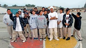 17 boys standing in a group on the playground