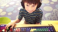 A boy wearing headphones works at a computer.
