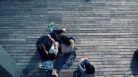 photo of a birds-eye-view of people sitting on a deck