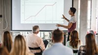 Student presenting data at a whiteboard