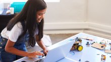 A middle school girl participates in a robotics club online