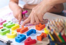 Preschooler plays with letter shapes