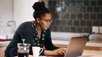 Woman working on laptop at home