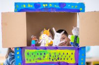 Children putting on a puppet show at home