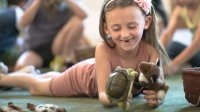 Elementary student plays with stuffed animals in class