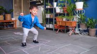 Preschool-aged boy playing hopscotch at home
