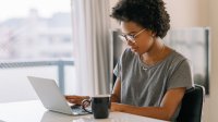 Woman working on laptop at home