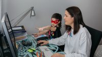 Mother and young daughter interact as mom tries to work at home. 