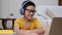 Elementary aged boy at home on computer for distance learning. 