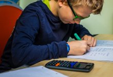 Middle school student working on a math assignment with a calculator