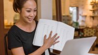 Teacher conducting distance learning lesson on her laptop at home