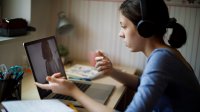 High school student participating in a virtual interview on her laptop