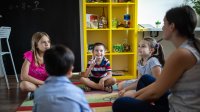 Elementary student holds up two fingers during circle time